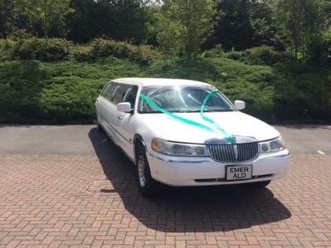 white stretch limousine with bar, disco lights and super sound system